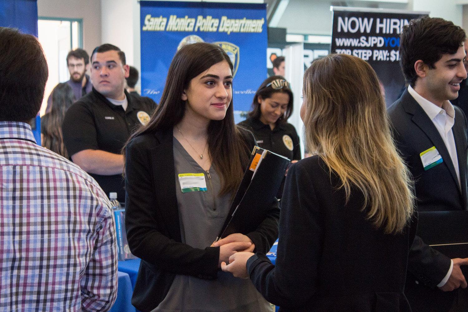photo of students and recruiters speaking for career fairs